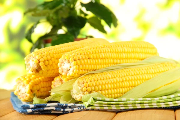 Crude corns on napkin on wooden table on window background — Stock Photo, Image