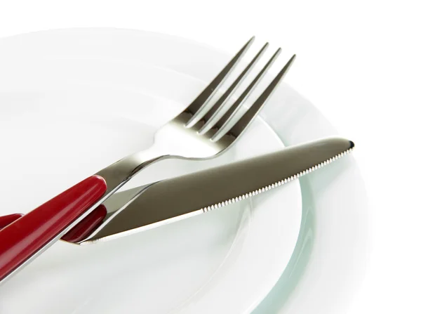 Coltello, piastra di colore e forchetta, isolato su bianco Fotografia Stock
