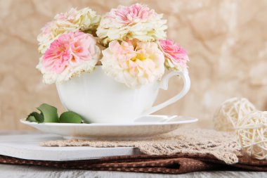 Gül Kupası peçete üzerinde bej renkli arka plan üzerinde ahşap masa üzerinde