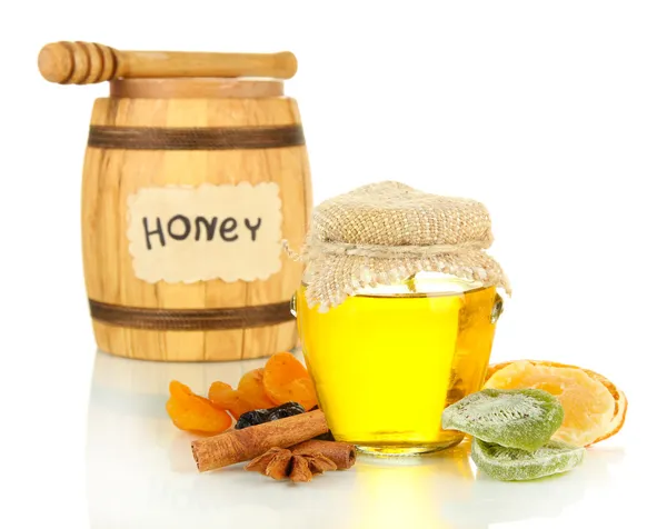 Jar of honey, wooden barrel, drizzler and dried fruits isolated on white — Stock Photo, Image