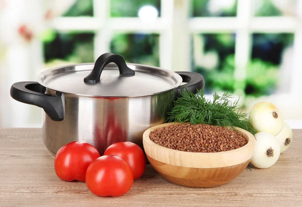 Ingredients for cooking buckwheat on table in kitchen — Stock Photo, Image