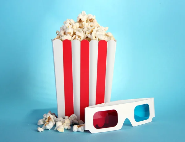 Popcorn and 3D glasses on blue background — Stock Photo, Image