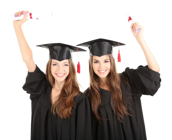 Dois estudantes graduados felizes isolados em branco — Fotografia de Stock