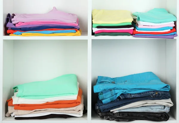 Clothes neatly folded on shelves — Stok fotoğraf