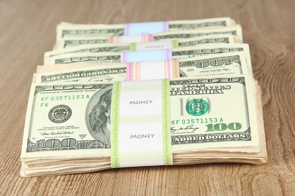 Stacks of money on wooden table — Stock Photo, Image