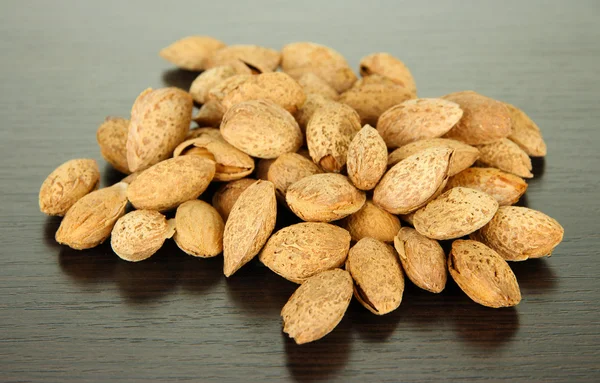 Almond on dark wooden background — Stock Photo, Image