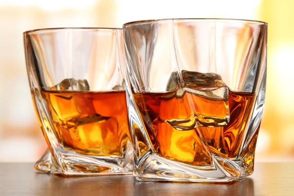 Glasses of whiskey, on bright background — Stock Photo, Image