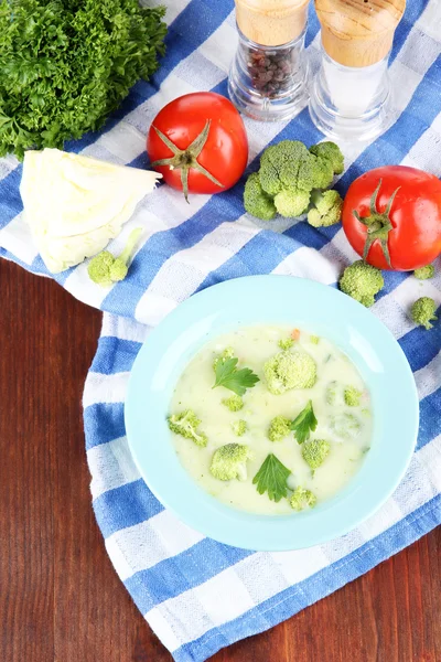 Cabbage soup in plates on napkin on wooden table — Stock Photo, Image