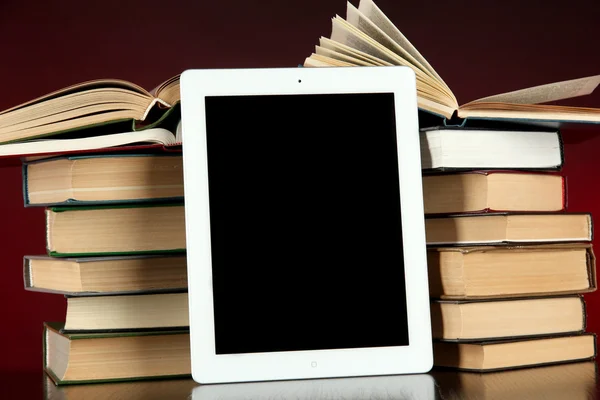 Tablet and books on bright background — Stock Photo, Image