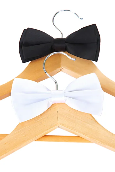 Black and white bow ties on wooden hangers, isolated on white — Stock Photo, Image