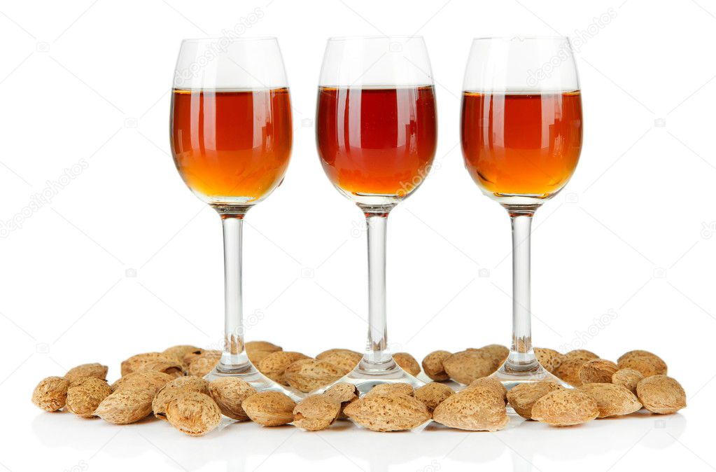 Glasses of amaretto liquor and roasted almonds, isolated on white