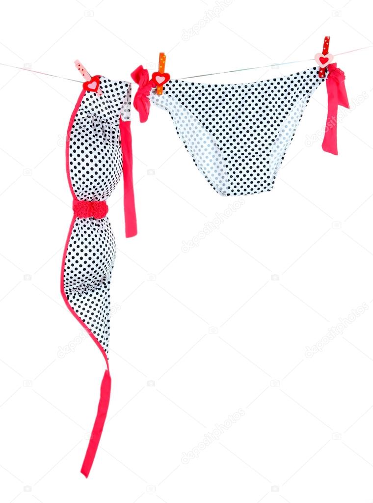 Women's swimsuit hanging on a rope isolated on white