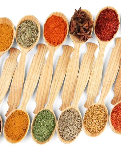 Assortment of spices in wooden spoons, isolated on white — Stock Photo, Image