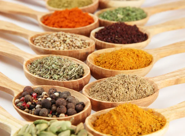 Assortment of spices in wooden spoons — Stock Photo, Image