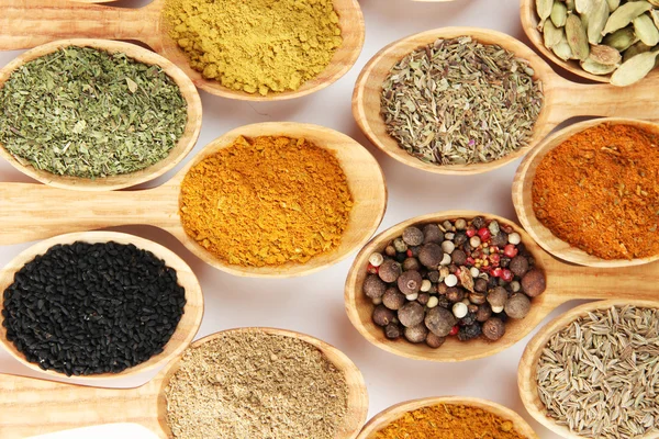 Assortment of spices in wooden spoons — Stock Photo, Image