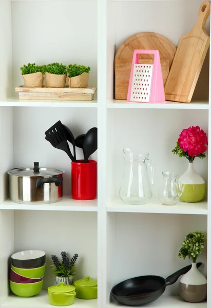 Beautiful white shelves with tableware and deco — Stock Photo, Image