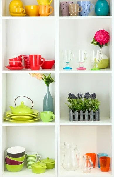 Beautiful white shelves with tableware and deco — Stock Photo, Image