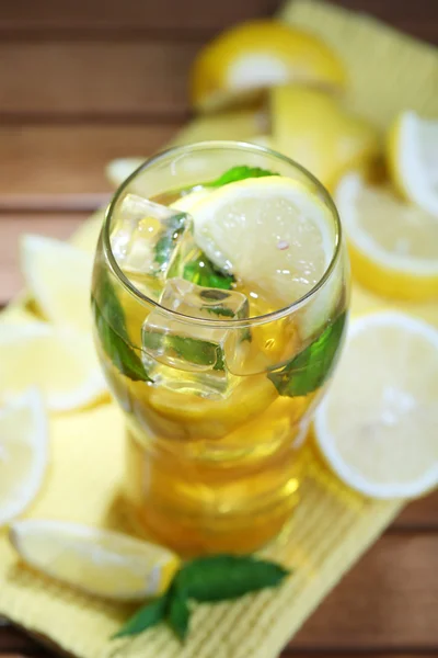 Iced tea with lemon and mint on wooden table — Stock Photo, Image