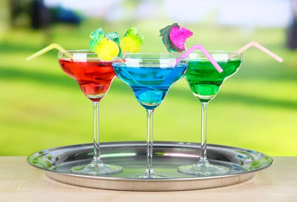 Different cocktails on bright background — Stock Photo, Image