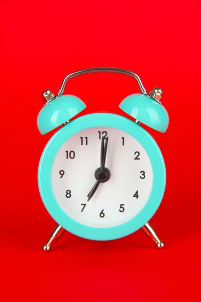 Blue alarm clock on red background — Stock Photo, Image