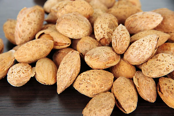 Almond on dark wooden background — Stock Photo, Image