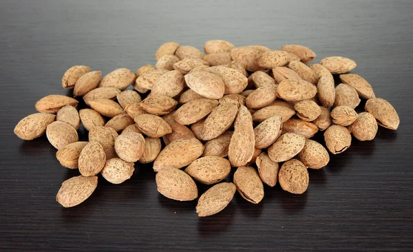 Almond on dark wooden background — Stock Photo, Image