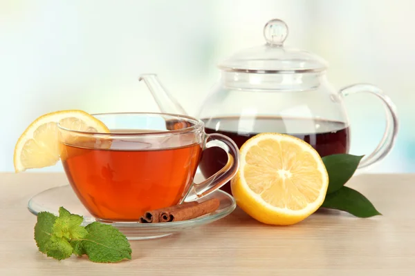 Cup of tea with lemon on table on light background — Stock Photo, Image