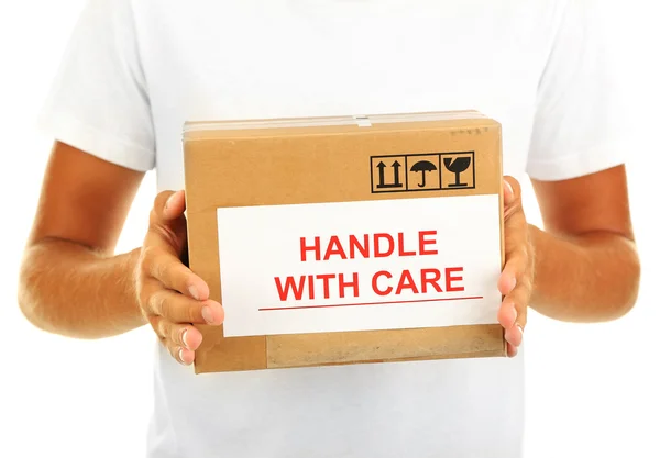 Young delivery man holding parcels, isolated on white — Stock Photo, Image