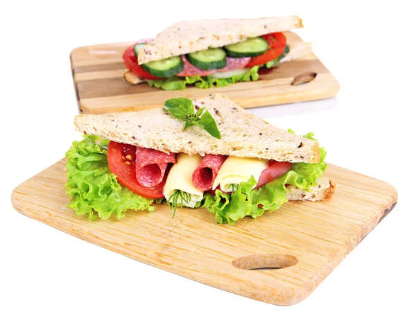 Tasty sandwiches with salami sausage and vegetables on cutting board, isolated on white — Stock Photo, Image
