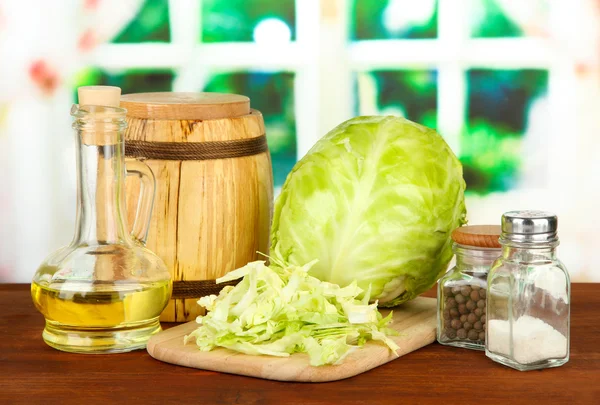 Green cabbage, oil, spices on cutting board, on bright background — Stock Image Green cabbage, oil, spices on cutting board, on bright background Stock Image