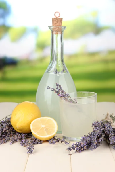 Lavender lemonade in bottle, on bright background — Stock Photo, Image