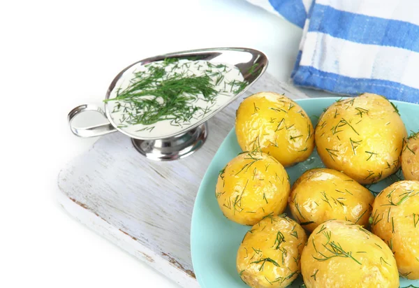 Boiled potatoes on platen on wooden board on napkin isolated on white — Stock Photo, Image