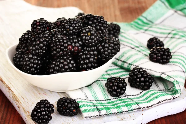 Söt blackberry i skål på träbord — Stockfoto