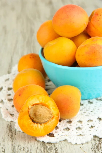 Fresh natural apricot in bowl on green wooden table — Stock Photo, Image