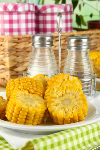 Flavored boiled corn on plate on wooden table on natural background — Stock Photo, Image