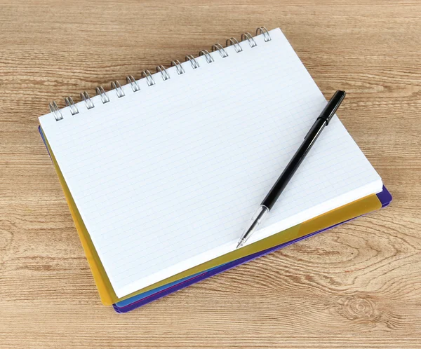 Notebook and pen on wooden table — Stock Photo, Image