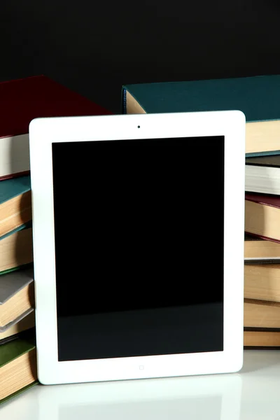 Tablet and books on bright background — Stock Photo, Image