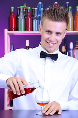 Barmen konyak cam içine yağıyor