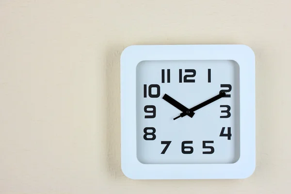 Office clock on color wall background — Stock Photo, Image