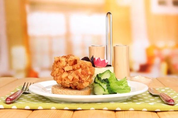 Chicken Kiev on croutons with mashed potatoes, on wooden table, on bright background — Stock Photo, Image