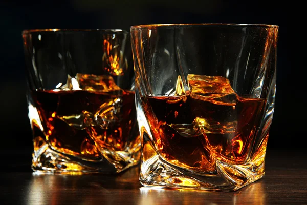 Glasses of whiskey, on dark background — Stock Photo, Image