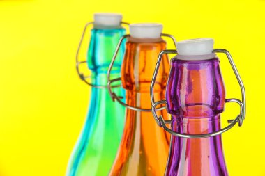 sarı arka plan üzerinde renkli şişe