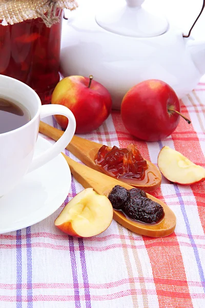 Light breakfast with tea and homemade jam, on tablecloth — Stock Photo, Image