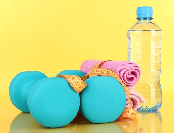 Dumbbells on yellow background — Stock Photo, Image