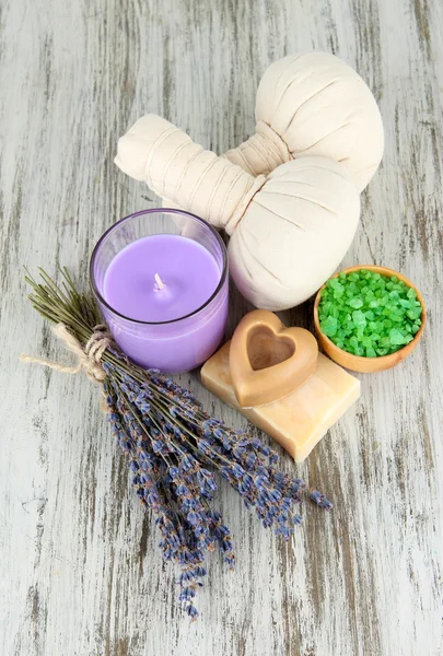 Bodegón con vela de lavanda, jabón, bolas de masaje, jabón y lavanda fresca, sobre fondo de madera — Foto de Stock