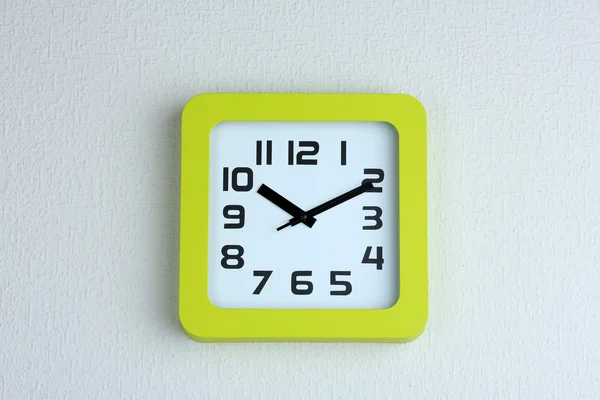 Office clock on color wall background — Stock Photo, Image