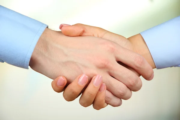 Business handshake on bright background — Stock Photo, Image