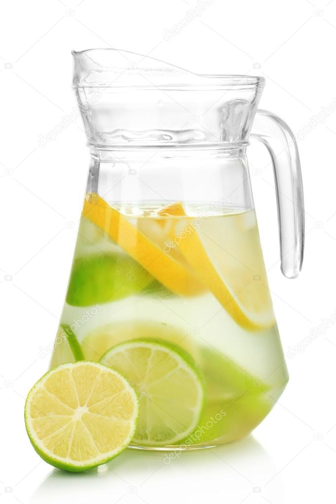 Cold water with lime, lemon and ice in pitcher isolated on white