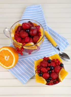 nuttige fruitsalade in glas cup en kom op houten tafel close-up