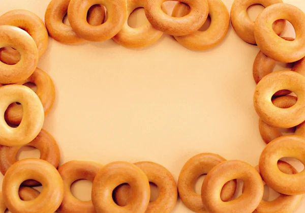 Tasty bagels, on beige background — Stock Photo, Image